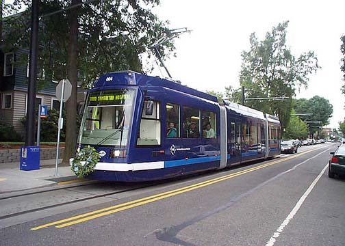Modern street car, also known as light rail, uses the sidewalks as loading platforms.